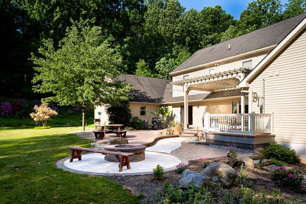 Boulders set among plants beside a covered outdoor area